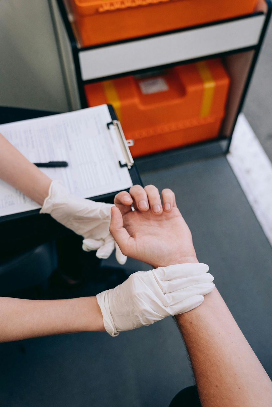 hands of medic in gloves and patient